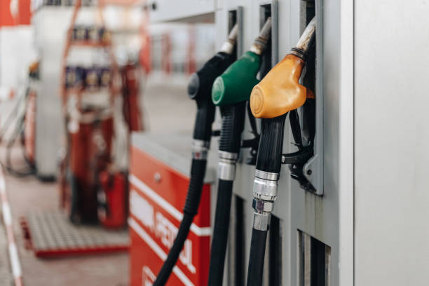 Gas station work Colorful Petrol pump filling nozzles at bright sunnz day. Gas station background. biofuel stock pictures, royalty-free photos & images