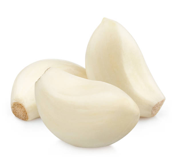istock Three delicious garlic cloves on white 1407853909
