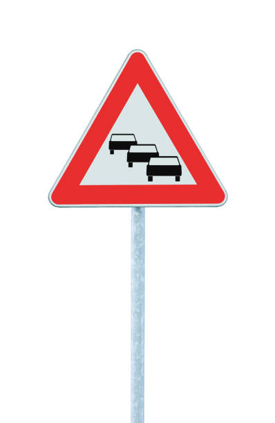 istock Traffic jam queues likely road sign, expect delays ahead warning isolated, traffic congestion symbol, red triangle, large detailed vertical closeup, grey pole post 1407856403