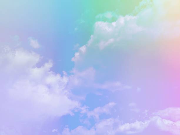 istock beauty sweet pastel soft green blue with fluffy clouds on sky. multi color rainbow image. abstract fantasy growing lights 1407856739