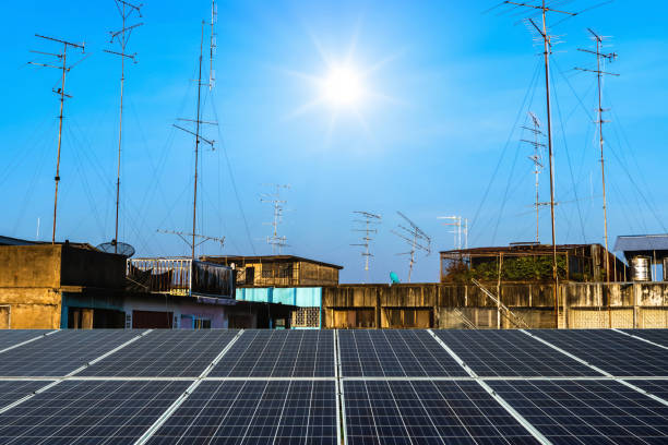 photovoltaic modules solar power plant with antenna and satellite on the roof with the house or building in country town city construction in provincial area in blue sky with cloud background - solar power station audio imagens e fotografias de stock