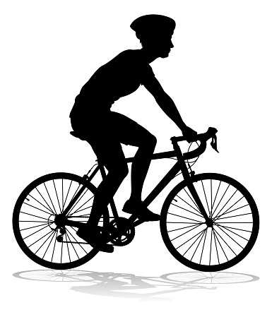 Bicyclist riding their bike and wearing a safety helmet in silhouette