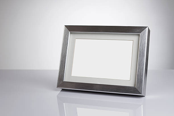 Blank photo frame Blank silver picture frame at the desk with clipping path table photos stock pictures, royalty-free photos & images