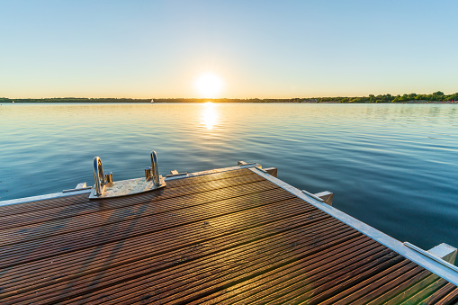 A beautiful sunset behind a jetty at the Cospudener See in summer