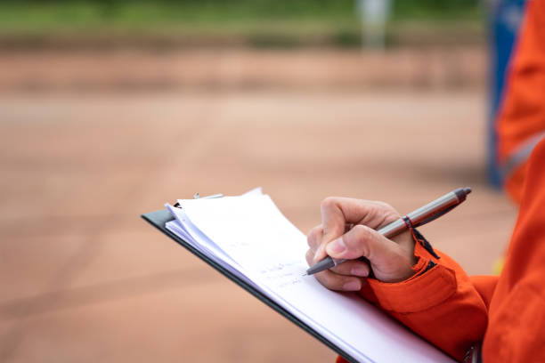 istock Writing note on paper - Audit and inspection in oil field operation. 1407863335