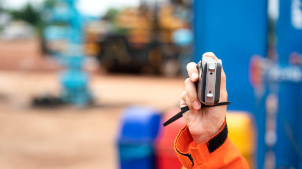 An auditor is taking photo - Industrial working. An auditor is using digital compact cemera taking photo during perform safety audit at construction site. Industrial working action scene photo, selective focus. evidence photos stock pictures, royalty-free photos & images