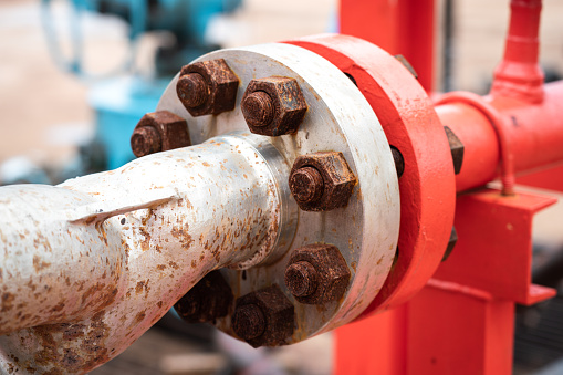 Heavy steel crude oil or gasoline transfer piping line at refinery plant. Industrial equipment object photo.