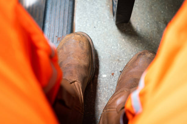 istock A worker is wearing safety shoe - Industrial working. 1407863463