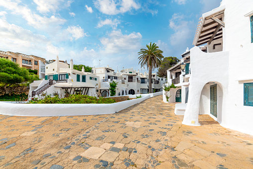 Whitewashed homes in the he picturesque white village of Binibeca Vell Spain on the Balearic island of Menorca in the Mediterranean Sea.