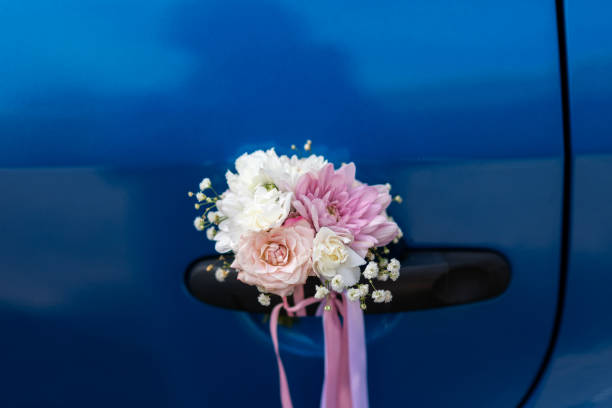 istock Wedding boutonniere on the handle of a blue car 1407866074