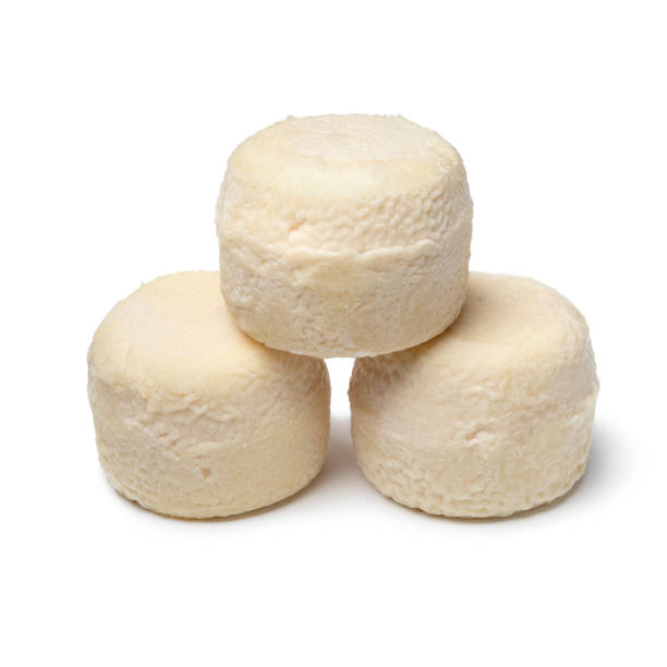 istock Three traditional small whole goat cheeses on white background close up 1407866329