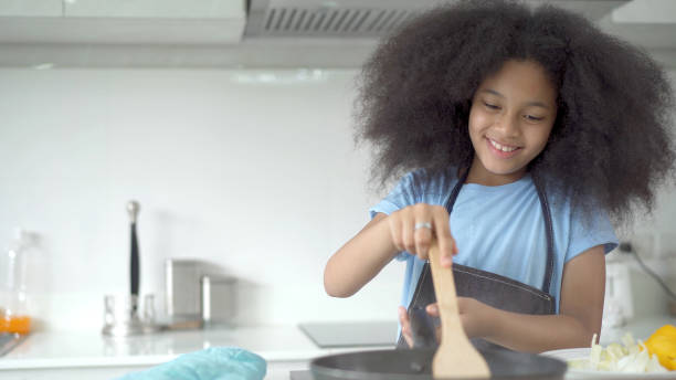 istock Little girl cooking together. 1407866415