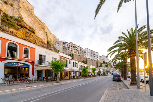 The historic walls and streets with shops and cafes at the harbor port town of Mahon Spain on the Mediterranean island of Menorca.