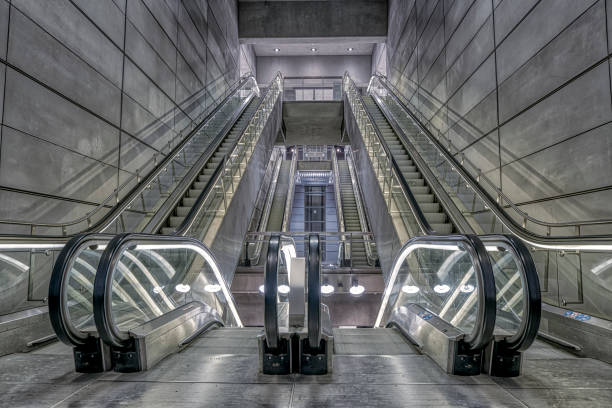 escalator in a grey futuristic light at the copenhagen metro stock photo