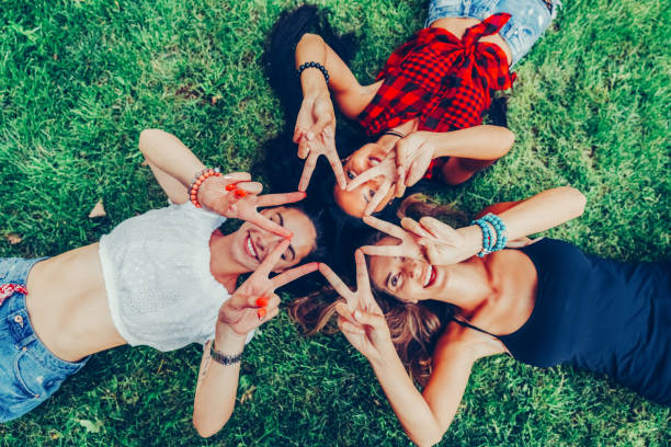 istock Attractive women among nature making star shape with fingers 1407872016