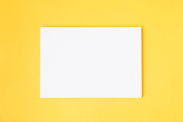 istock White blank paper card on a yellow background 1407873272