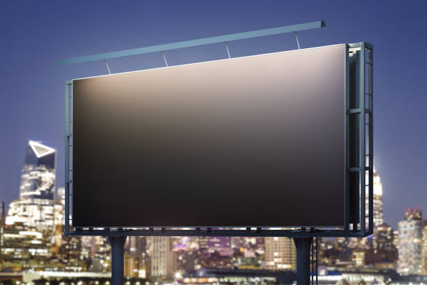 istock Blank black horizontal billboard on cityscape background at night, perspective view. Mockup, advertising concept 1407876165