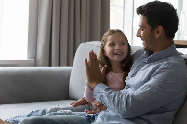 istock Happy daughter giving high five to loving dad 1407878131