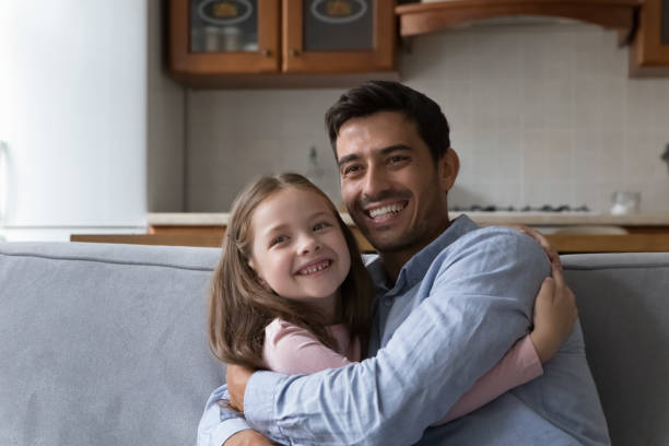 istock Loving Hispanic father cuddles his preschool daughter 1407878134