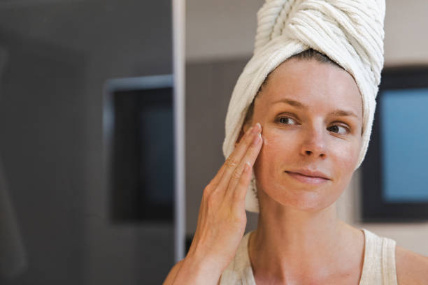 Woman Applying Moisturizing Face Cream