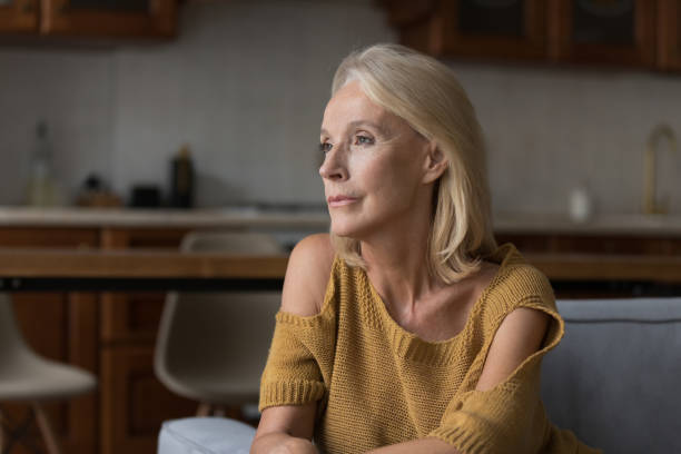 istock Thoughtful female in nostalgic mood thinking, looking into distance 1407878370