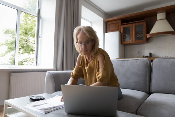 istock Serious aged woman make accounting work from home 1407879124