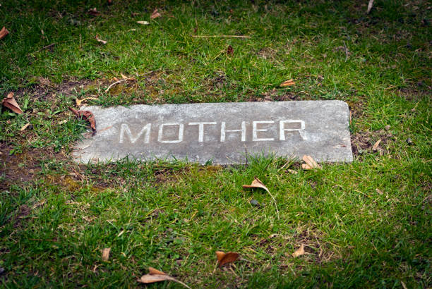 Cemetery headstone in summer with no name, close up, balnk and ready to add your own text to the nameplate as a design element.