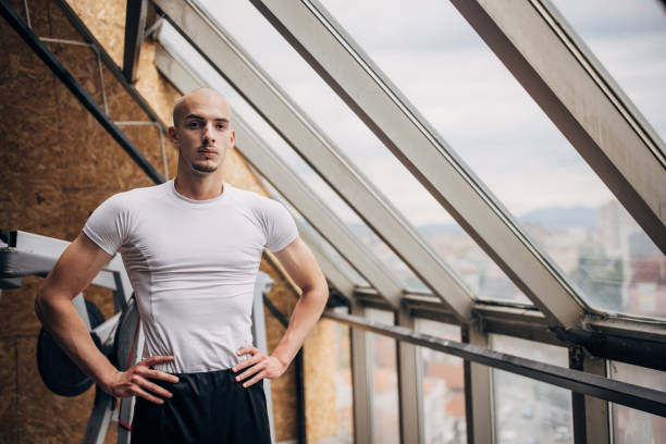 One man, fit man standing in gym.