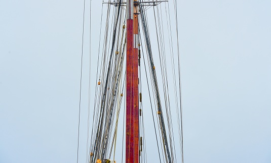 Tall ship mast in sunshine, low angle view, background with copy space, full frame horizontal composition