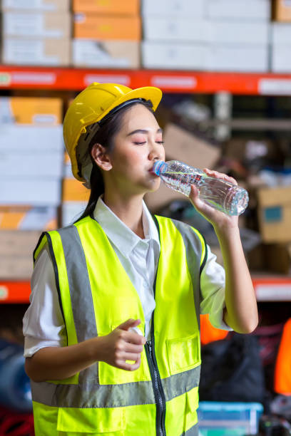 istock Worker drinking water in factory site. 1407887202