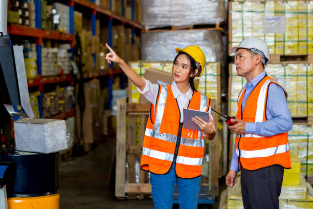 istock Team Foreman or Team worker working in warehouse. Industrial and industrial workers concept. worker woman order details and checking goods and Supplies. 1407888237