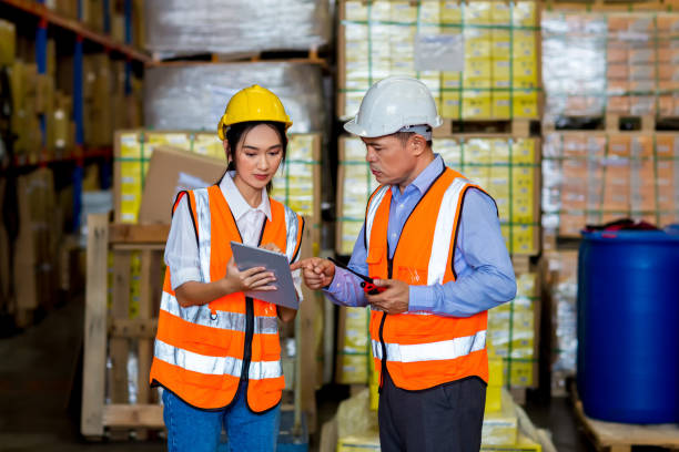 istock Team Foreman or Team worker working in warehouse. Industrial and industrial workers concept. worker woman order details and checking goods and Supplies. 1407888253