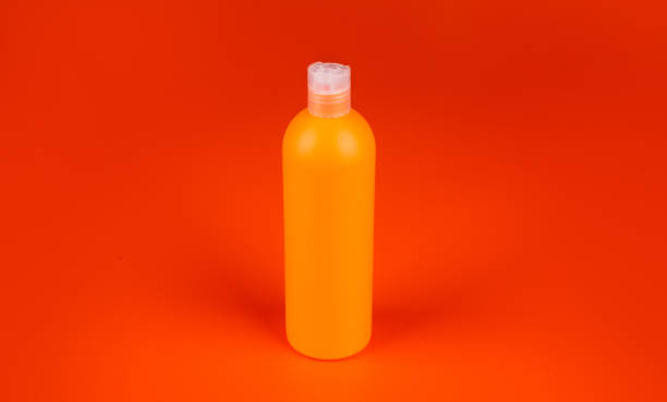 istock shampoo bottle on orange background, beauty product 1407889468