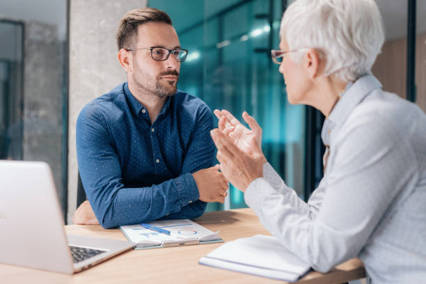 istock Two business people working together in office 1407892517