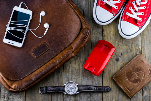 A set of men's things from a sneaker with a bag and a smartphone with a watch.
