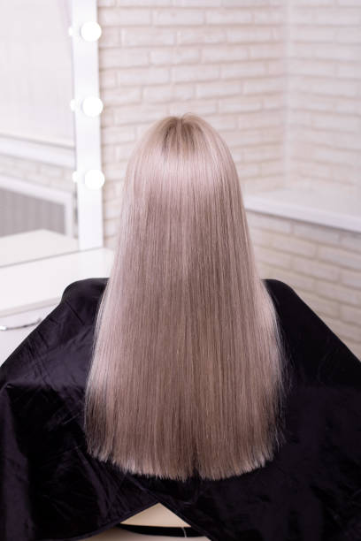 istock Female back with long, straight, blonde hair 1407893210
