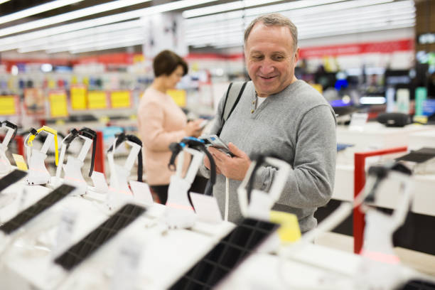 istock European man chooses a mobile phone 1407894236