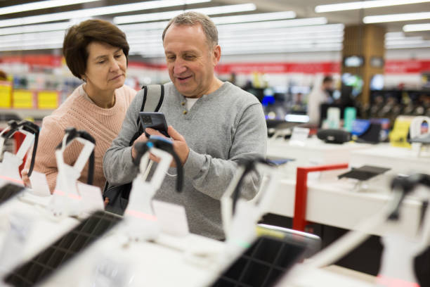 istock European man chooses a mobile phone 1407894243