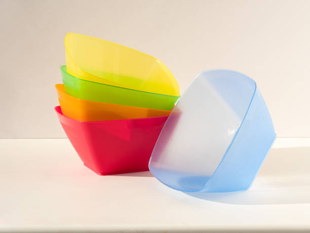 istock A stack of bright colorful square-shaped plastic salad bowls. The blue plate is next to the stack 1407895705