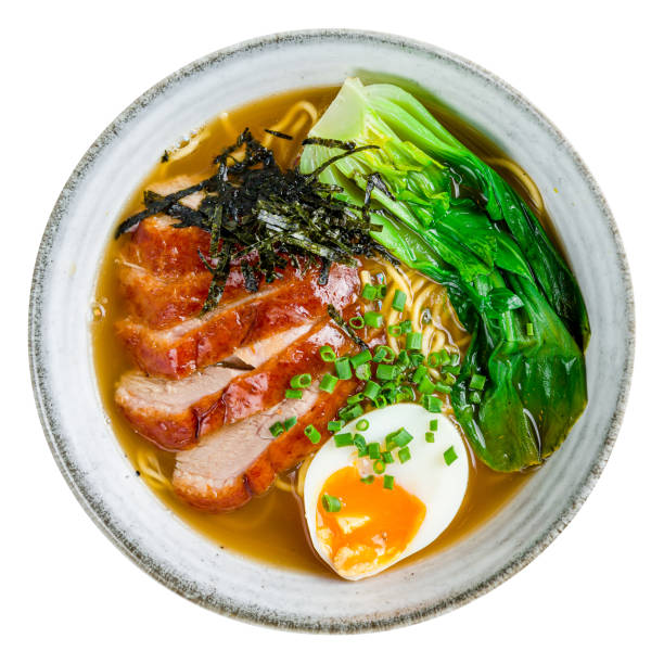 Ramen soup with duck, noodles and egg top view on dark stone table