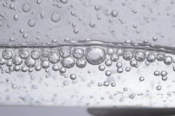 istock air bubbles in a transparent liquid close-up. micro. 1407897456