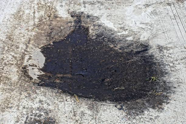 istock one large dry puddle of black mud on the gray sand 1407897500