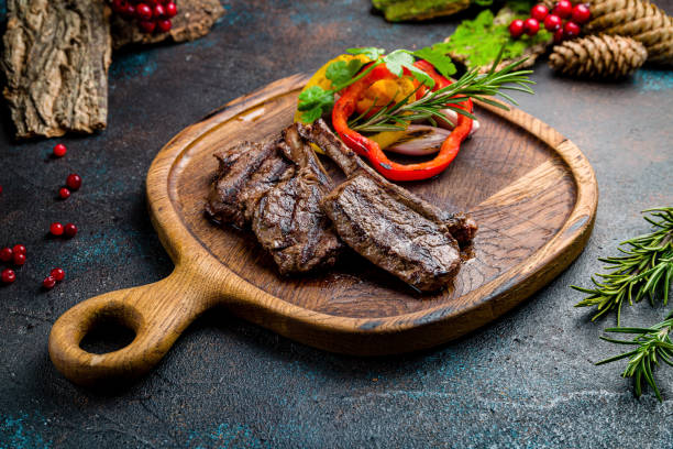 istock Rack of lamb on the board on dark table 1407898574