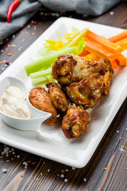 istock Chicken wings with blue cheese sauce on wooden table 1407898637