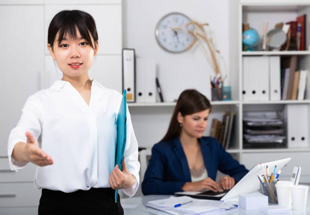 istock Successful chinese businesswoman ready for handshake 1407900301