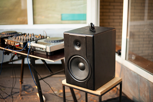 Musical equipment. Big speaker. Sound cabin on street. Dj's place of work. Remote control for broadcasting loud music.