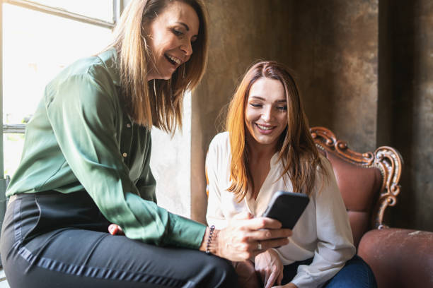 istock Business women relaxing in the back office using smartphone 1407904446