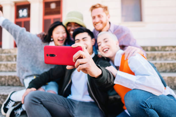 istock Group of multiracial friends taking a selfie together while posing and smile. 1407906557