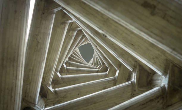 Endless tunnel optical illusion, multiple triangles in torsion effect. Inside view of the clock tower located in the  in the Rectorate Square at Central University of Venezuela