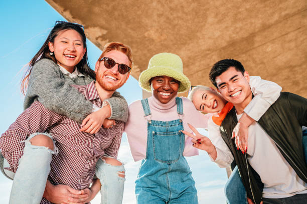 istock Group of five multiracial friends smiling and having fun looking at camera. 1407907632